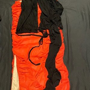 Local Boutique outfit. Black wrap around top and red spandex skirt with slit.